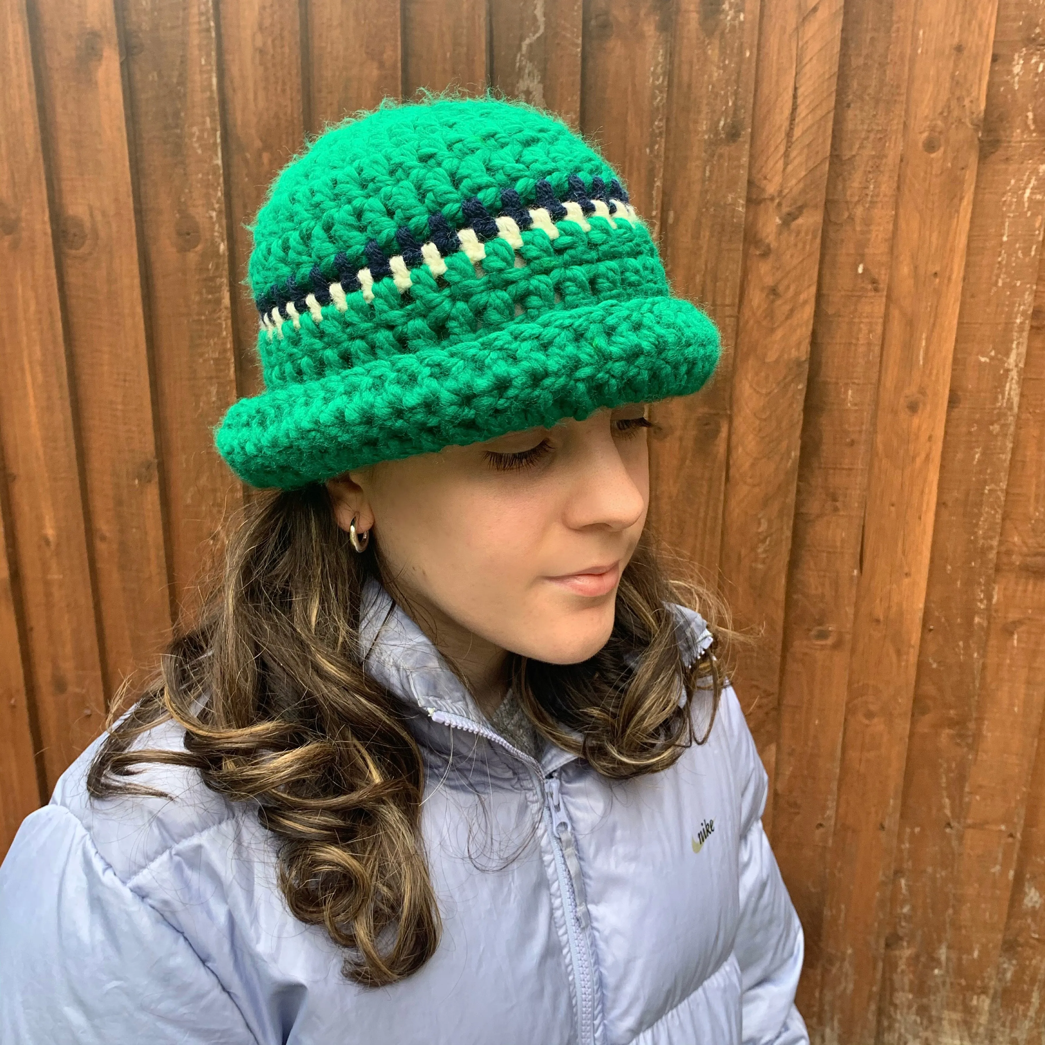 Handmade forest green chunky crochet bowler hat with cream and navy stripes